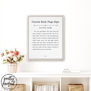 Puede incluir: Un letrero de pared rectangular enmarcado con fondo blanco y texto negro que dice Custom Book Page Sign, AUTHOR NAME, e incluye instrucciones de personalizaci&oacute;n. El letrero presenta una l&iacute;nea divisoria decorativa y el n&uacute;mero 34 abajo.