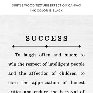 May include: Black and white typography print with the word "SUCCESS" and a quote about laughing often, winning respect, and earning appreciation. The quote is printed on a wood-textured background.