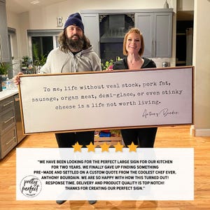 May include: A white wooden sign with a black frame and a quote from Anthony Bourdain that reads "To me, life without veal stock, pork fat, sausage, organ meat, demi-glace, or even stinky cheese is a life not worth living."