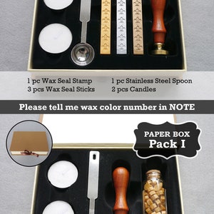 May include: Two open boxes containing wax seal kits. The top box contains a wax seal stamp, three wax sticks, a spoon, and two candles. The bottom box contains a wax seal stamp, a bottle of wax beads, a spoon, and two candles. The text "PAPER BOX Pack H" is on the top box and "PAPER BOX Pack I" is on the bottom box.
