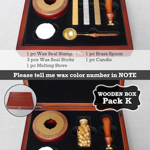 May include: Two open wooden boxes with black velvet interiors containing wax seal kits. The top box contains a wax seal stamp, three wax sticks, a melting stove, a brass spoon, and a candle. The bottom box contains a wax seal stamp, a bottle of wax beads, a melting stove, a brass spoon, and a candle. Both boxes have a label that says "Wooden Box" and the pack letter.