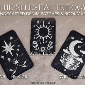 May include: Three rectangular black denim patches featuring white embroidered celestial designs. The left patch shows stars, the center patch displays a sun with flowers labeled XVIII - THE SUN, and the right patch depicts a moon labeled XVIII - THE MOON.
