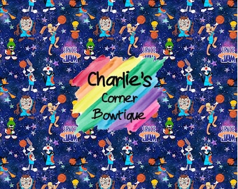 May include: A colorful, rainbow-themed pattern featuring cartoon characters from the movie Space Jam. The characters are playing basketball against a dark blue background with stars. The text "Charlie's Corner Bowtique" is written in a rainbow font.