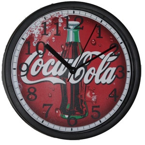 May include: Black and red round wall clock with a Coca-Cola bottle and logo on the face. The clock has black hands and white numbers.