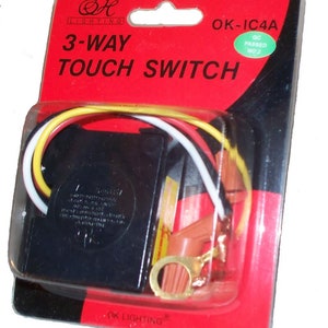 May include: A black 3-way touch switch with red and yellow wires in a clear plastic package. The package is red and has the text "OK-IC4A" and "OK LIGHTING" printed on it. The switch is labeled "3-WAY TOUCH SWITCH".