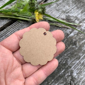 May include: A brown scalloped circle gift tag with a hole punched in the top.