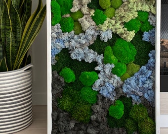 May include: A framed moss wall art piece with a variety of green, gray, and blue moss textures. The moss is arranged in a natural, organic pattern.