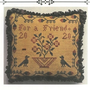 May include: A cross stitch kit for a pillow featuring a floral design with birds and the text "For a Friend." The kit is from La-D-Da designs for counted thread.