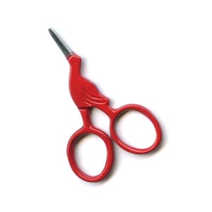 May include: Red metal scissors with a bird-shaped handle. The scissors have a pointed tip and two round loops.