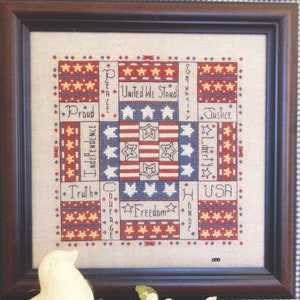 May include: A cross-stitch pattern for a square design featuring a red, white, and blue color scheme. The design includes stars, stripes, and the words "Independence", "United We Stand", "Justice", "Liberty", "Truth", "Courage", "Freedom", and "USA".
