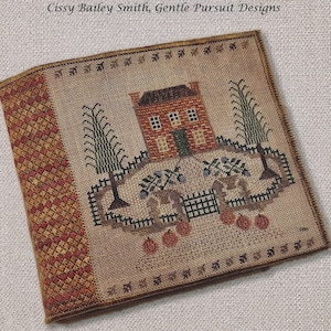 May include: A cross-stitch sampler featuring a brown house with a red brick facade, two green trees, and a fence. The sampler is surrounded by a brown border with a red and orange checkered pattern. The text "Autumn Sampler Compendium" and "Cissy Bailey Smith, Gentle Pursuit Designs" is included.