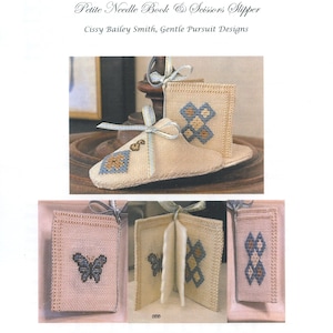 May include: A needle book and scissor slipper cross stitch pattern. The pattern features a butterfly and a geometric design. The pattern is by Cissy Bailey Smith, Gentle Pursuit Designs.