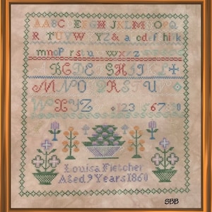 May include: A framed cross-stitch sampler with a beige background. The sampler features a colorful alphabet, numbers, and floral motifs. The text "Louisa Fletcher Aged 9 Years 1860" is stitched in the bottom center.