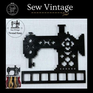 May include: Black sewing machine thread organizer with 8 slots. The organizer is shaped like a sewing machine and has a decorative design. The text "Sew Vintage .Thread Keep." is printed on the organizer.