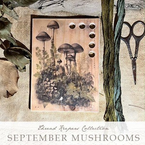 May include: A vintage-style card with a mushroom illustration and the text "Thread Keeper Collection SEPTEMBER MUSHROOMS 2023 COLLECTION BY THE PRIMITIVE HARE".
