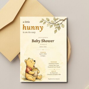 May include: A cream-colored baby shower invitation card featuring a watercolor illustration of Winnie the Pooh holding a honey pot, a leafy branch, and the text: a little hunny is on its way, Baby Shower in honor of Jane Doe, April 1, 2026.