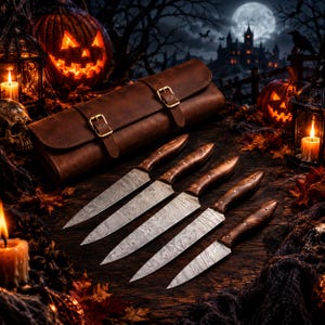 May include: A set of five knives with patterned metal blades and dark brown wooden handles, arranged in a row next to a brown leather roll case with two brass-colored buckles. The knives feature distinct wavy patterns on the steel blades.