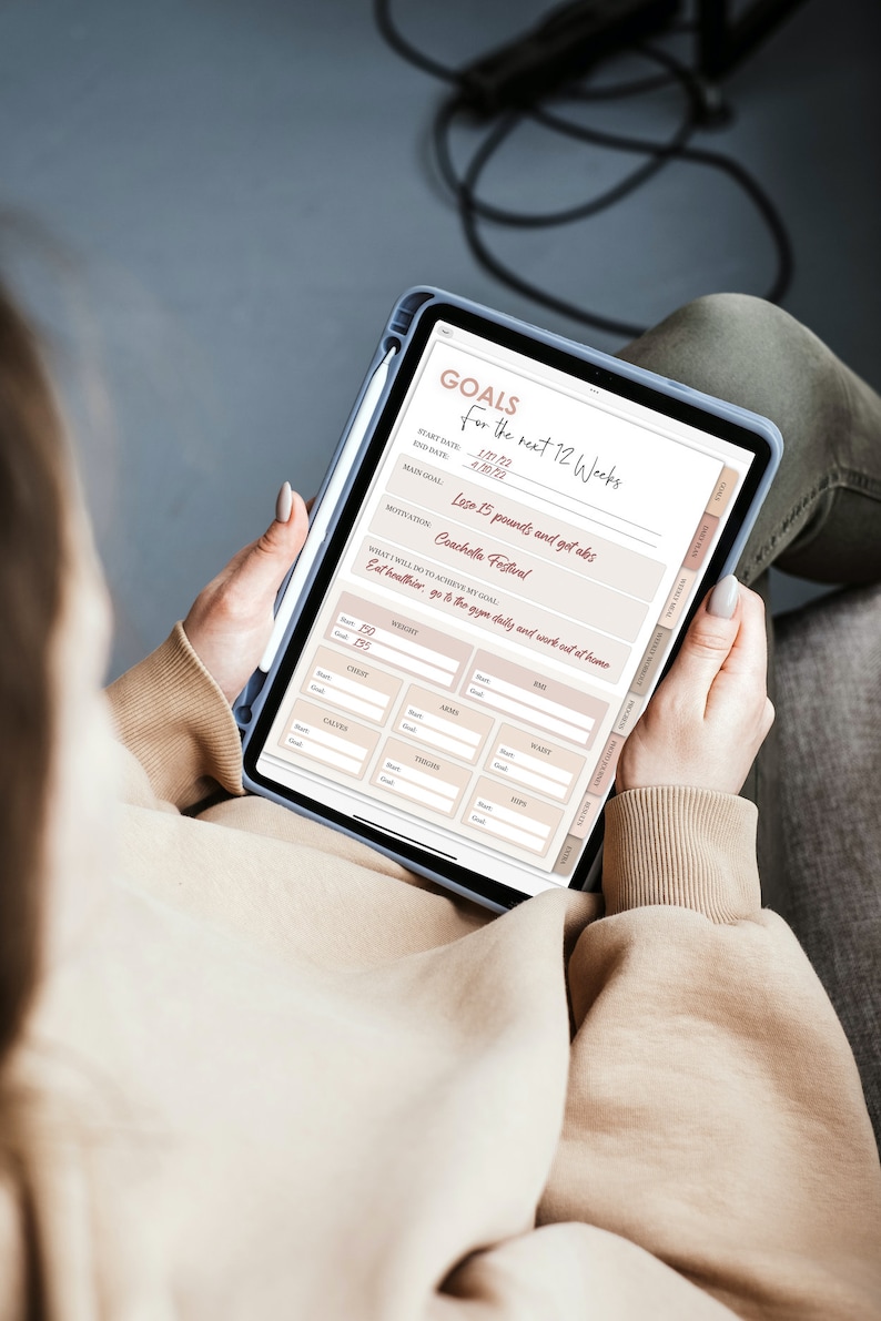 May include: A digital tablet with a goal setting worksheet for the next 12 weeks. The main goal is to lose 15 pounds and get abs for Coachella Festival. The worksheet includes sections for weight, chest, arms, waist, thighs, and hips.
