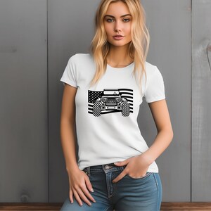 May include: White t-shirt featuring a black and white graphic of a Jeep in front of an American flag.