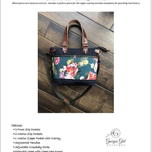 May include: A teal and floral fabric tote bag with brown leather handles and a zipper closure. The bag has a crossbody strap and is 12 1/2 inches wide, 9 inches high, and 3 1/2 inches deep. The bag is labelled "Cami Bag" and is an intermediate level sewing project.