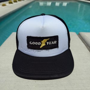 Vintage Goodyear Tires Logo Patch on a White and Black Mesh Trucker Hat