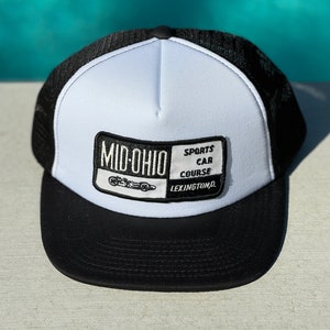 May include: A white and black trucker hat with a black patch that says "Mid-Ohio Sports Car Course Lexington, OH".
