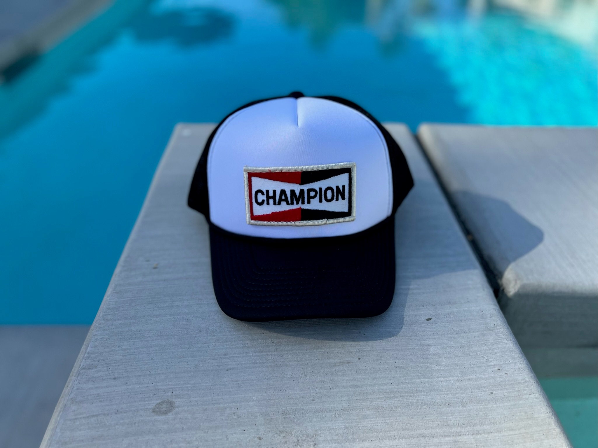 Vintage Champion Spark Plug Logo Patch on a White and Black Mesh