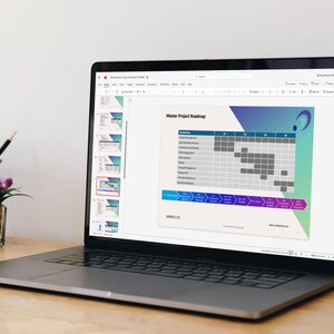 May include: A laptop displaying a Master Project Roadmap presentation slide with a Gantt chart, project milestones, and a blue and purple graphic design. The screen shows a slide deck interface with a sidebar of thumbnails and a top toolbar.