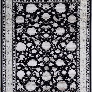 A 5.5x7.9 ft hand-knotted rug featuring a large, ornate ivory and blue central medallion on a deep navy blue field. The field is filled with intricate scrolling vines and small floral motifs. A wide, multi-layered border in ivory and light blue frames the rug. The rug is made of wool with silk highlights that give it a subtle sheen, finished with a short white fringe at the top and bottom.