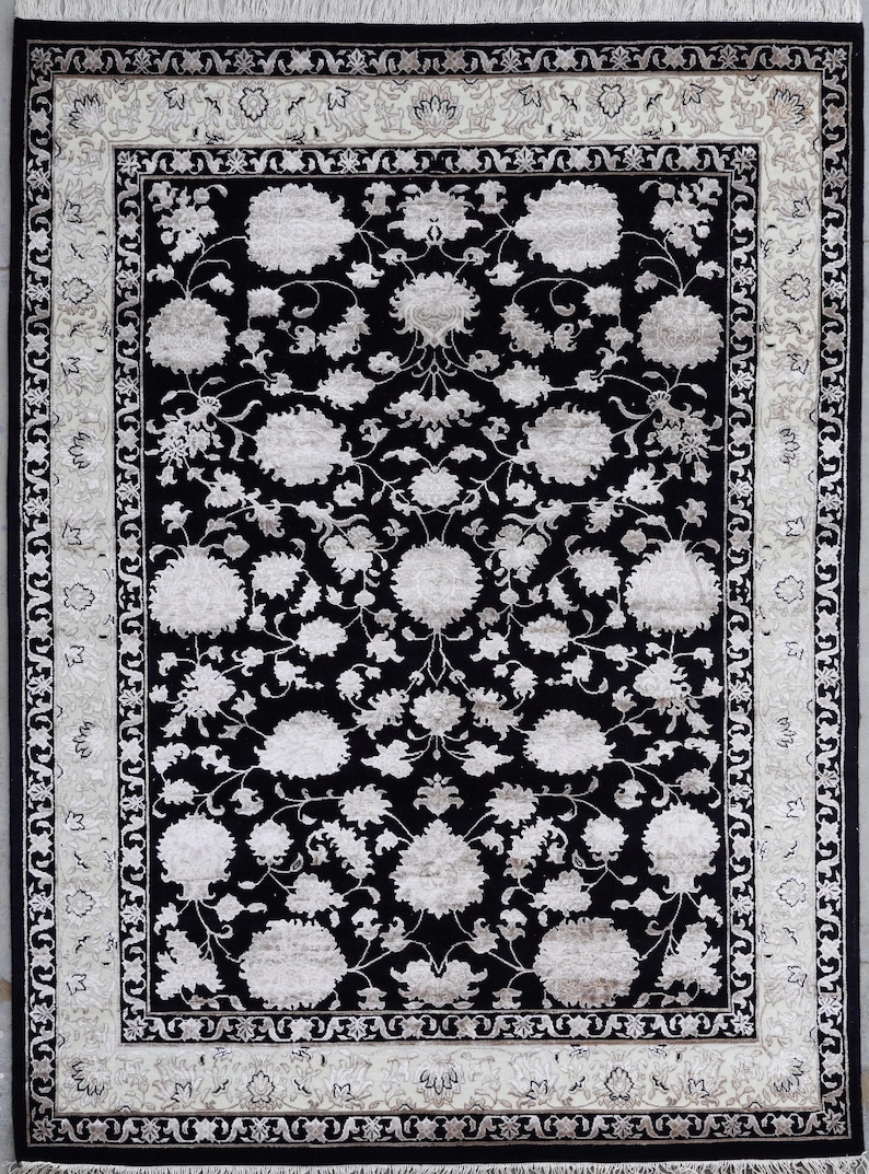A 5.5x7.9 ft hand-knotted rug featuring a large, ornate ivory and blue central medallion on a deep navy blue field. The field is filled with intricate scrolling vines and small floral motifs. A wide, multi-layered border in ivory and light blue frames the rug. The rug is made of wool with silk highlights that give it a subtle sheen, finished with a short white fringe at the top and bottom.