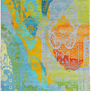 Hand-knotted wool Oushak rug in paisley pattern; rolled samples in teal, blue, orange for a textured floor decor rug.