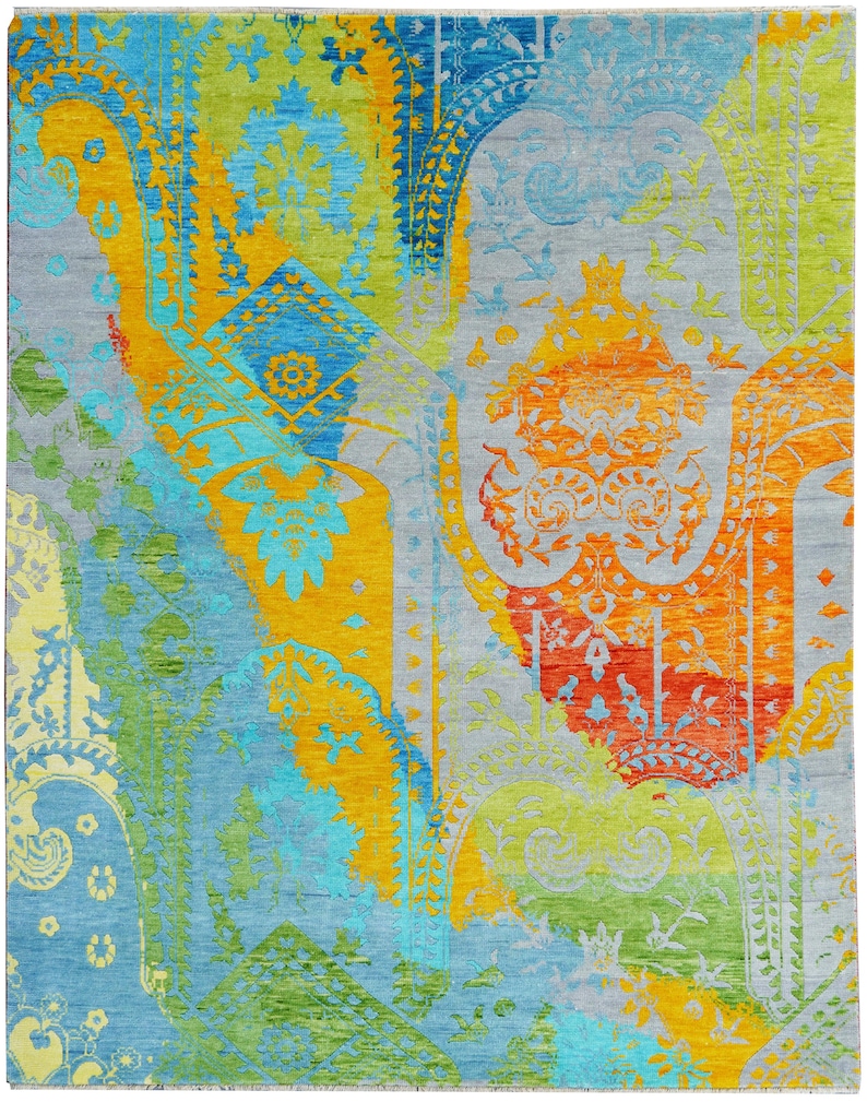 Hand-knotted wool Oushak rug in paisley pattern; rolled samples in teal, blue, orange for a textured floor decor rug.