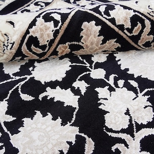 A 5.5x7.9 ft hand-knotted rug featuring a large, ornate ivory and blue central medallion on a deep navy blue field. The field is filled with intricate scrolling vines and small floral motifs. A wide, multi-layered border in ivory and light blue frames the rug. The rug is made of wool with silk highlights that give it a subtle sheen, finished with a short white fringe at the top and bottom.
