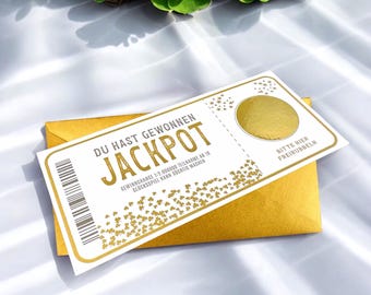 May include: A white scratch-off ticket with gold lettering that reads "DU HAST GEWONNEN JACKPOT" and "GEWINNCHANCE 1:7.000000 TEILNAHME AB 18 GLUCKSSPIEL KANN SUCHTIG MACHEN". The ticket has a gold circle with a scratch-off area that says "BITTE HIER FREIRUBBELN".