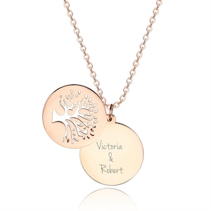 May include: A rose gold necklace with two round pendants. The top pendant features a cut-out tree design. The bottom pendant is engraved with the text "Victoria & Robert".