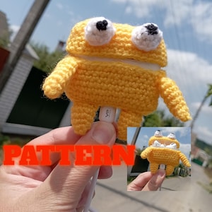 May include: A yellow crocheted frog-shaped case for earbuds. The case has white and black eyes, arms, and legs. The word "PATTERN" is overlaid on the image in orange letters. A smaller image of the case is in the bottom right corner.