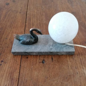Art deco night light lamp on marble with a swan.