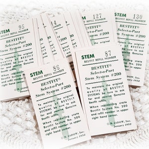 May include: A stack of white paper labels with green text. The labels are for a product called "BESTFIT Select-a-Part Stem System #200". The labels have instructions on how to maintain the original quality of the product and how to reorder refills. The labels are dated January 1952.