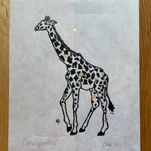 May include: Black and white linocut print of a giraffe with a spotted pattern. The giraffe is standing on a white background. The print includes the word "Camelopardalis" and the artist's signature.