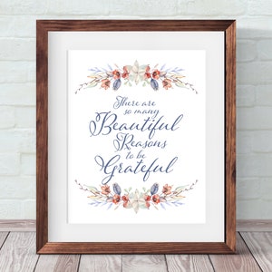 May include: A framed print with a watercolour floral wreath and the text "There are so many Beautiful Reasons to be Grateful".