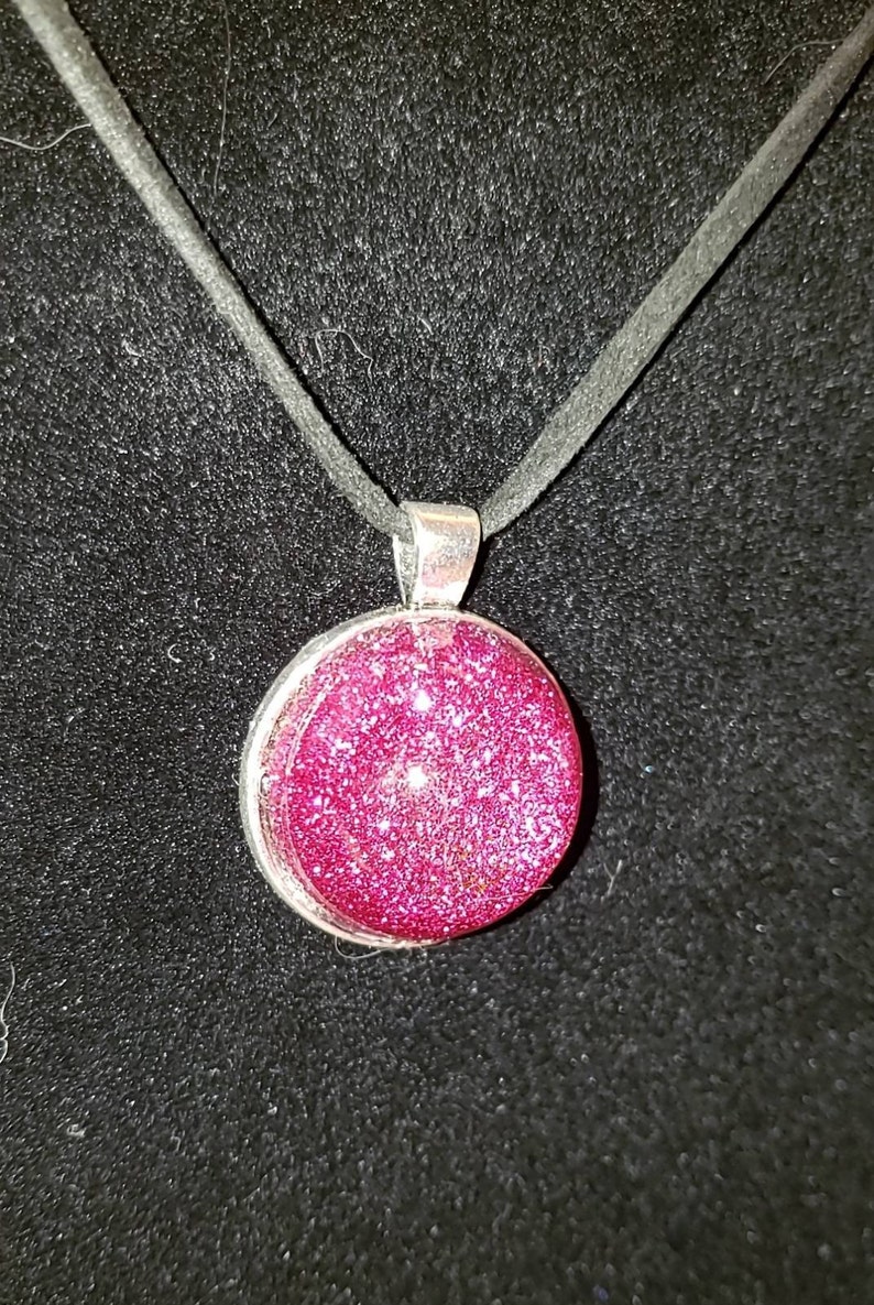 Pink glitter circle charm necklace.
