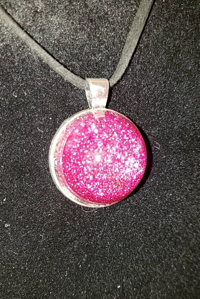 Pink glitter circle charm necklace.