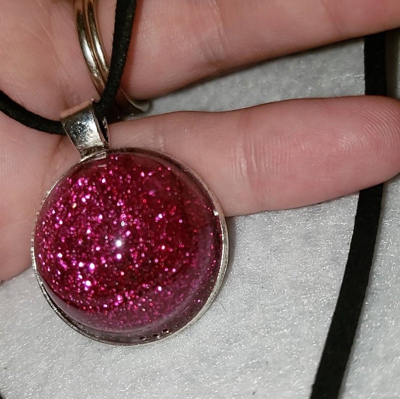 Pink glitter circle charm necklace.