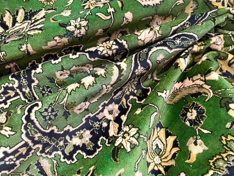 May include: A green rug with a floral pattern. The rug has a traditional Persian design with intricate details and a rich color palette.