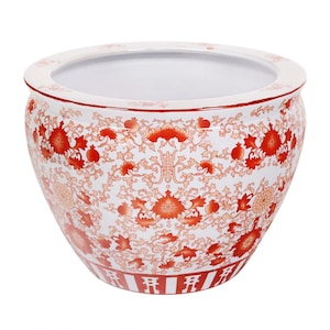 May include: A round, white ceramic planter with a wide opening and a red floral pattern. The planter features a repeating design of flowers and foliage in shades of red and orange. The rim and base have red accents.