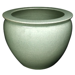 May include: A celadon green ceramic planter with a wide, rounded body and a slightly flared rim. The surface has a crackle glaze effect, adding texture and visual interest. This decorative pot is suitable for indoor or outdoor use.