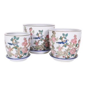 May include: Set of three white ceramic flower pots with matching saucers. Each pot features a detailed design of pink roses, blue birds, and green foliage. The pots have a blue rim and are suitable for indoor or outdoor use.