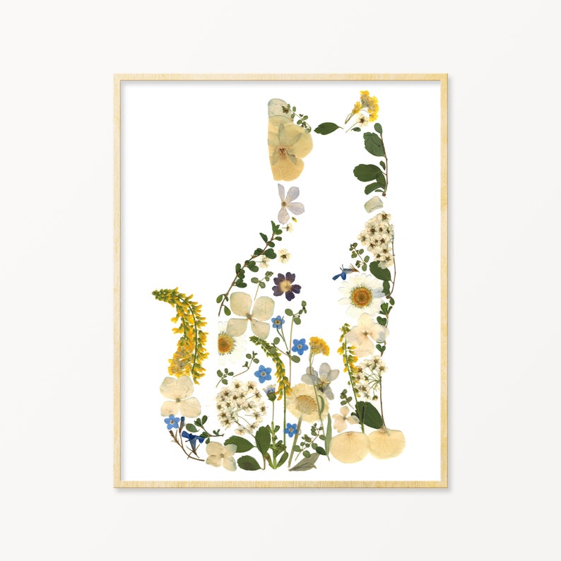 May include: A framed print of a cat silhouette made from pressed flowers. The flowers are in shades of white, yellow, blue, and purple.