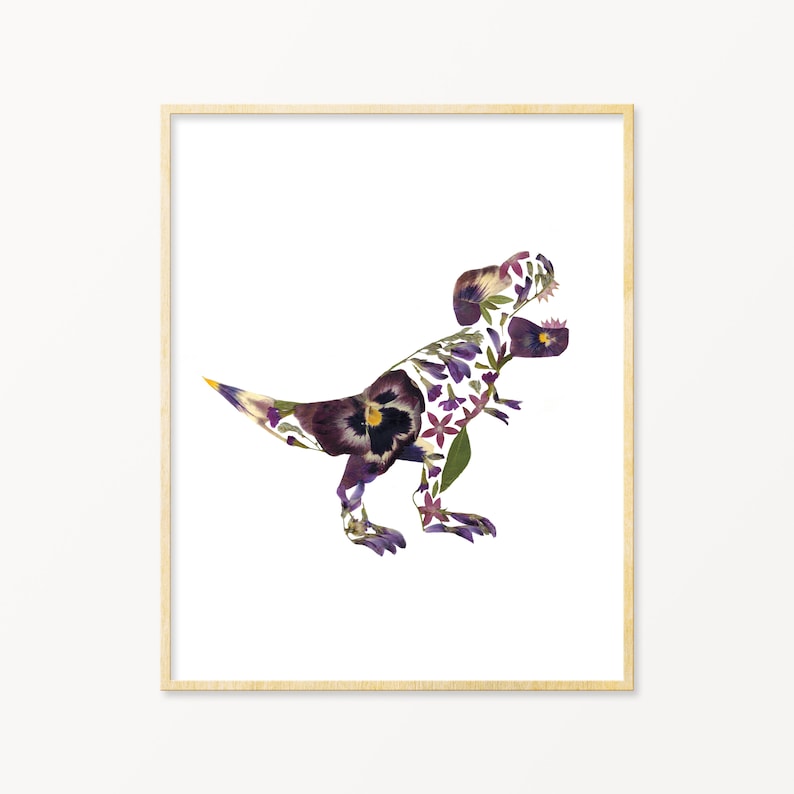 May include: A framed print of a Tyrannosaurus Rex dinosaur silhouette made from pressed flowers. The dinosaur is made from purple, white, and yellow flowers.