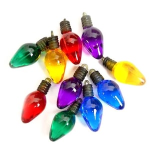 May include: Assortment of ten miniature Christmas light bulbs in various colors, including red, green, blue, yellow, and purple.